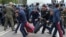 Полицейские задерживают участника протеста в Нур-Султане в день досрочных президентских выборов. 9 июня 2019 года.