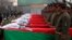 Afghan honor guards stand next to coffins as they pay tribute to soldiers who were killed in an Taliban attack in Kunar province.