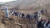 Afghan villagers gather at the site of a landslide in the Argo district in Badakhshan Province on May 2.