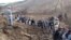 Afghan villagers gather at the site of a landslide in the Argo district in Badakhshan Province on May 2.