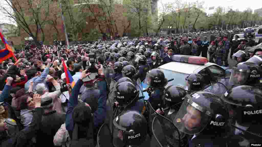 Riot police confront opposition protesters in Yerevan.