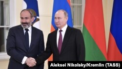 RUSSIA -- Russian President Vladimir Putin, shakes hands with acting Armenian Prime Minister Nikol Pashinian at the Eurasian Economic Council in St. Petersburg, December 6, 2018