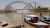 A man wades next to his boat along the Indus River near the Lansdowne Bridge in Sukkur, in Pakistan's southern Sindh Province on April 28. 