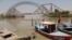 A man wades next to his boat along the Indus River near the Lansdowne Bridge in Sukkur, in Pakistan's southern Sindh Province on April 28. 