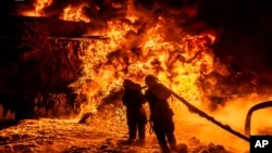 Emergency services extinguish a fire following a Russian attack in Kharkiv region, Ukraine, on July 5.