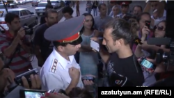 Armenia - A civic activist argues with Yerevan's Deputy Police Chief Valeri Osipian, Yerevan, 05Sep2013