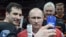 Russian President Vladimir Putin (center) and Roman Rotenberg (left) pose for a selfie after a gala ice hockey match in Sochi in 2016. SKA St. Petersburg's president, Gennady Timchenko, is third from the left. 