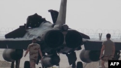 French military support staff walk towards a Rafale fighter jet. (file photo)