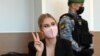 Lyubov Sobol flashes a "victory" sign in court in Moscow on March 10.