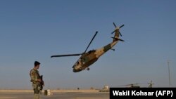 Ооган жоокери тик учакты байкоодо. Лашкар Гах, Гелманд вилайети, Ооганстан. 2021-жылдын 25-марты.