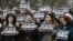 Spain -- Spanish journalists hold posters reading 'Je suis Charlie' (I am Charlie) to show their solidarity with the victims of the massacre at the headquarters of French satirical magazine Charlie Hebdo in Paris during a minute of silence in Pamplona, no