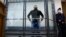 Andrei Pivovarov stands behind the glass during a court session in Krasnodar on June 2.