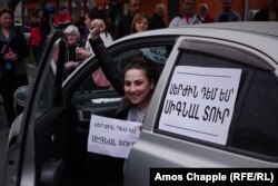 The sign on the car says: "Deny Serzh by honking your horn."