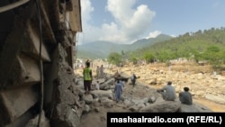 Rescuers and local residents search for bodies buried under rubble in Bunar district on August 16.