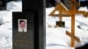 Russia -- A picture of lawyer Sergei Magnitsky is seen on his grave in the Preobrazhensky cemetery in Moscow, 11Mar2013