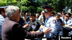 Riot police detain demonstrators in Almaty during a protest against an unpopular land-reform proposal in May 2016. The moratorium was introduced after protests erupted across the country.