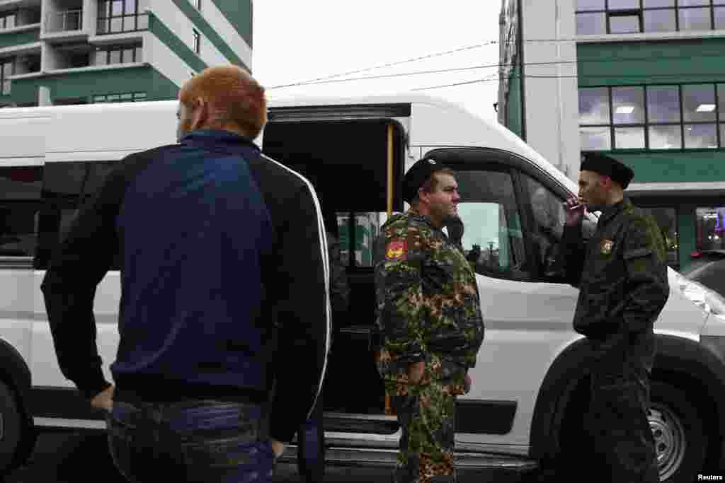 Полиция Сочи урамнарында рөхсәтсез мигрантларны аулаган арада тәмәке тарта.