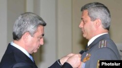 Armenian President Serzh Sarkisian decorates a senior police official on April 16, 2009
