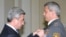 Armenian President Serzh Sarkisian decorates a senior police official on April 16, 2009