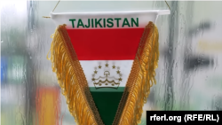 Флаг Таджикистана в кабине грузовика в Литве. Мигранты-дальнобойщики из Центральной Азии часто украшают свои машины вещами, которые напоминают им о родине.