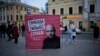 People walk past an election poster with a portrait of Andrei Pivovarov with the words "Freedom is stronger than fear!" in Moscow on September 7.