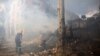 Firefighters extinguish a fire at a damaged school building following shelling in the town of Kramatorsk on July 21.
