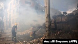 Firefighters extinguish a fire at a damaged school building following shelling in the town of Kramatorsk on July 21.