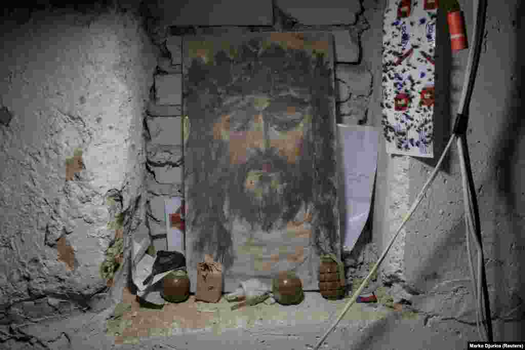 Христостун cүрөтүнүн алдында коюлган гранаталар.&nbsp; Харьков облусундагы фронттогу &quot;Карпатская Сечь&quot; батальонунун алдыңкы операциялык базасы.