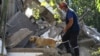 Armenian -- A rescuer and a sniffer dog search through the rubble of an apartment building severely damaged by an explosion, Yerevan, August 26, 2020.