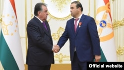 Президент Таджикистана Эмомали Рахмон после вручения ордена своему зятю Шамсулло Сохибову (справа). 