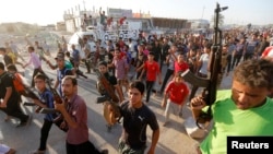 “Ирак менен Леванттагы ислам мамлекети”  (ИЛИМ) куралчан тобуна каршы согушка катталган шийилердин кошуундары. Багдад, 15- июнь, 2014.