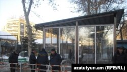 Armenian police guard a kiosk under construction in Yerevan's Mashtot Park.