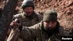 Ukrainian soldiers are seen inside a trench outside the frontline town of Bakhmut on March 4.