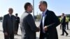 NATO Secretary-General Jens Stoltenberg (right) is greeted by Serbian Defense Minister Aleksandar Vulin in Belgrade on October 6. 