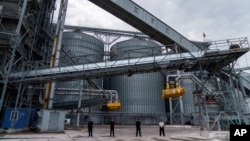 Security personnel stand in front of a grain storage terminal at Ukraine's Odesa sea port on July 29.