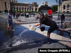 Sona Ghazarian, 20, cleans Republic Square along with her university classmates. The linguistics student says her group headed to the square, which was the scene of a huge protest rally on May 2, and will spend three hours scrubbing it clean. “We have come here because we love our country, and we want to show our support for what is happening on the streets. I want everything in my country to be fair. We all love Armenia and we want the best for her.”