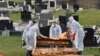 BOSNIA-HERZEGOVINA -- A man gestures as workers exhume the coffin of 21-year-old Bosnian student David Dragicevic at a cemetery in the northern town of Banja Luka, March 12, 2019