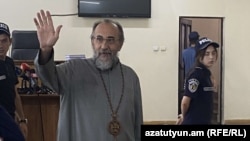 Armenia - Archbishop Mikayel Ajapahian greets supporters during his trial in Yerevan, August 28, 2025.