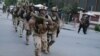 Afghan and international special forces run to the site of a clash between Afghan security forces and Taliban fighters in Kabul on May 24. 