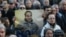 A protester holds a picture of Artur Sarkisian at a rally in Yerevan on March 17.