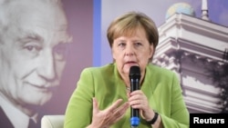 Georgia -- German Chancellor Angela Merkel gestures as she meets with students at the university in Tbilisi, Georgia August 24, 2018.