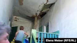 Разваливающуюся крышу в доме № 16 в Старом городе подпирают деревянными балками. Темиртау, 15 августа 2015 года. 