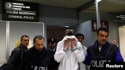 Валерий Толмачев в окружении полицейских в римском аэропорту. 25 апреля 2011 г