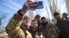 Ukrainian President Volodymyr Zelenskiy poses with soldiers during a visit to newly liberated Kherson on November 14.