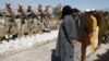 Taliban militants who were arrested by Afghan police stand during a presentation of seized weapons and equipment in Jalalabad on March 2.