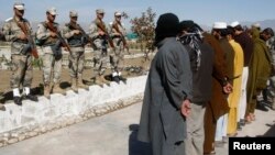 Taliban militants who were arrested by Afghan police stand during a presentation of seized weapons and equipment in Jalalabad on March 2.