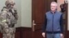 Penza Governor Ivan Belozertsev (right) appears in court on March 22.