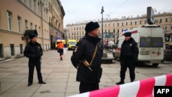 Police guard the entrance to the subway station in St. Petersburg where 14 people were killed on April 3.