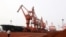 Soil containing various rare-earth elements waits to be loaded on to a ship at a port in Lianyungang, China. (File photo)