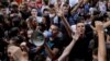Primary school students shout slogans during a protest in Belgrade on June 19.